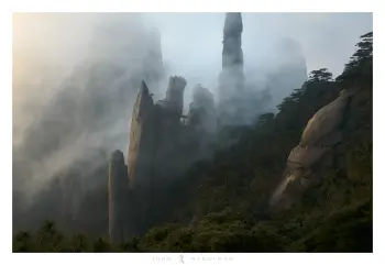 An alien like figure looks out over tall peaks and foggy mountains in China